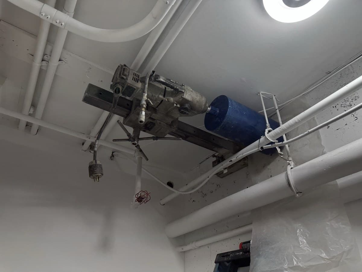 Overhead core drilling through concrete ceiling